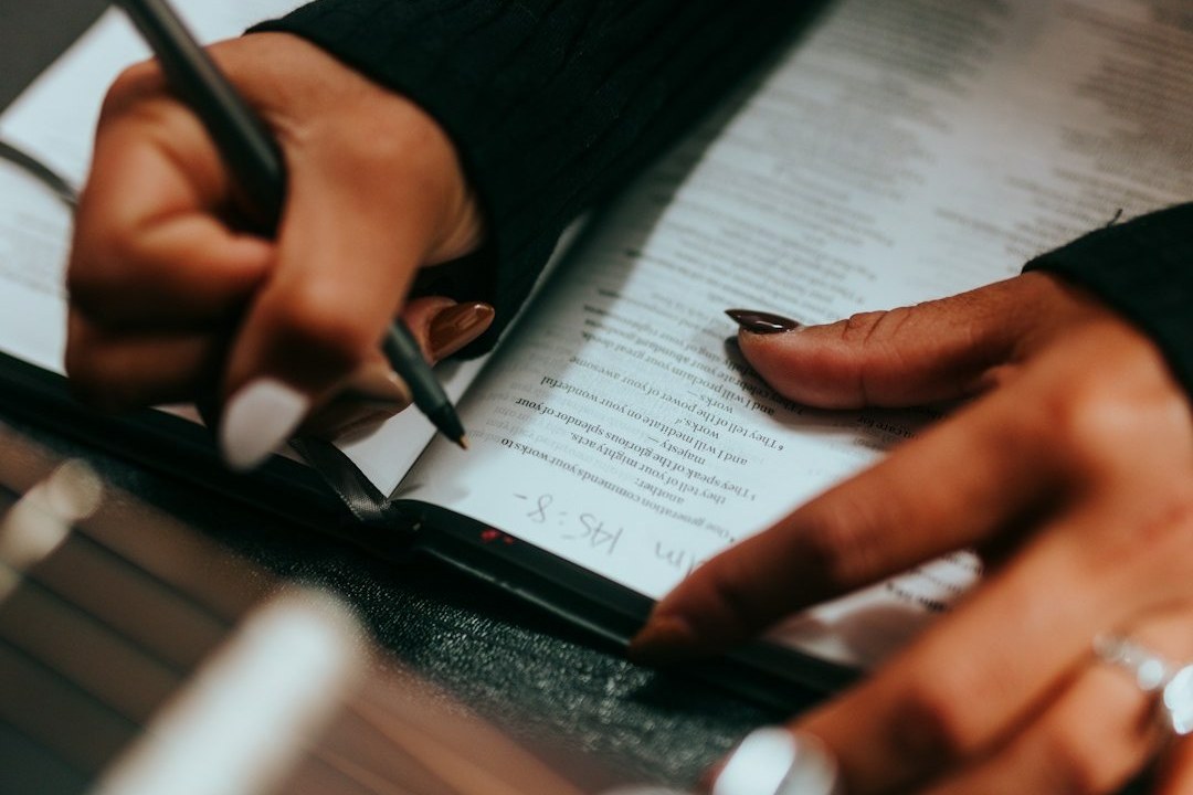 Person schreibt ein Anschreiben für die Ausbildung am Schreibtisch